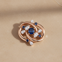 Ultra high-resolution product photo of necklace pendant without the chain.
Minimal, premium style on a smooth, flat warm stone background.  
Jewellery lying flat on the surface.  
Clean studio lighting with gentle highlights on metal and gemstones.  
Square format (1:1).  
Single hero piece centred, filling about 65% of the frame with space around it.  
Looks professionally restored and like new.  
No text, no logos, no people.
